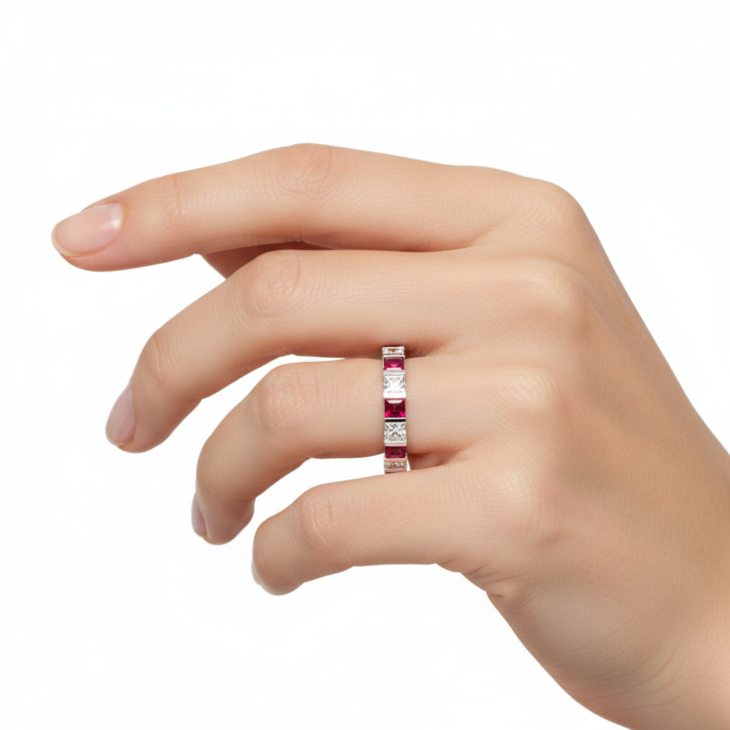 14k gold princess diamond and ruby eternity wedding band on model, showcasing sparkling gemstones and elegant design.