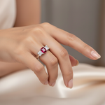 14k gold three-stone ruby and diamond fashion ring on a hand, showcasing the elegant design and sparkling gemstones.