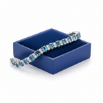 Swiss blue topaz bracelet on royal blue wooden box