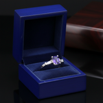 14k white gold three stone Tanzanite diamond fashion ring with 1.86 carats total, displayed in a royal blue box.