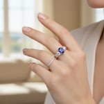 14k gold oval tanzanite and diamond fashion ring on hand, showcasing elegant jewelry with sparkling stones and detailed design.