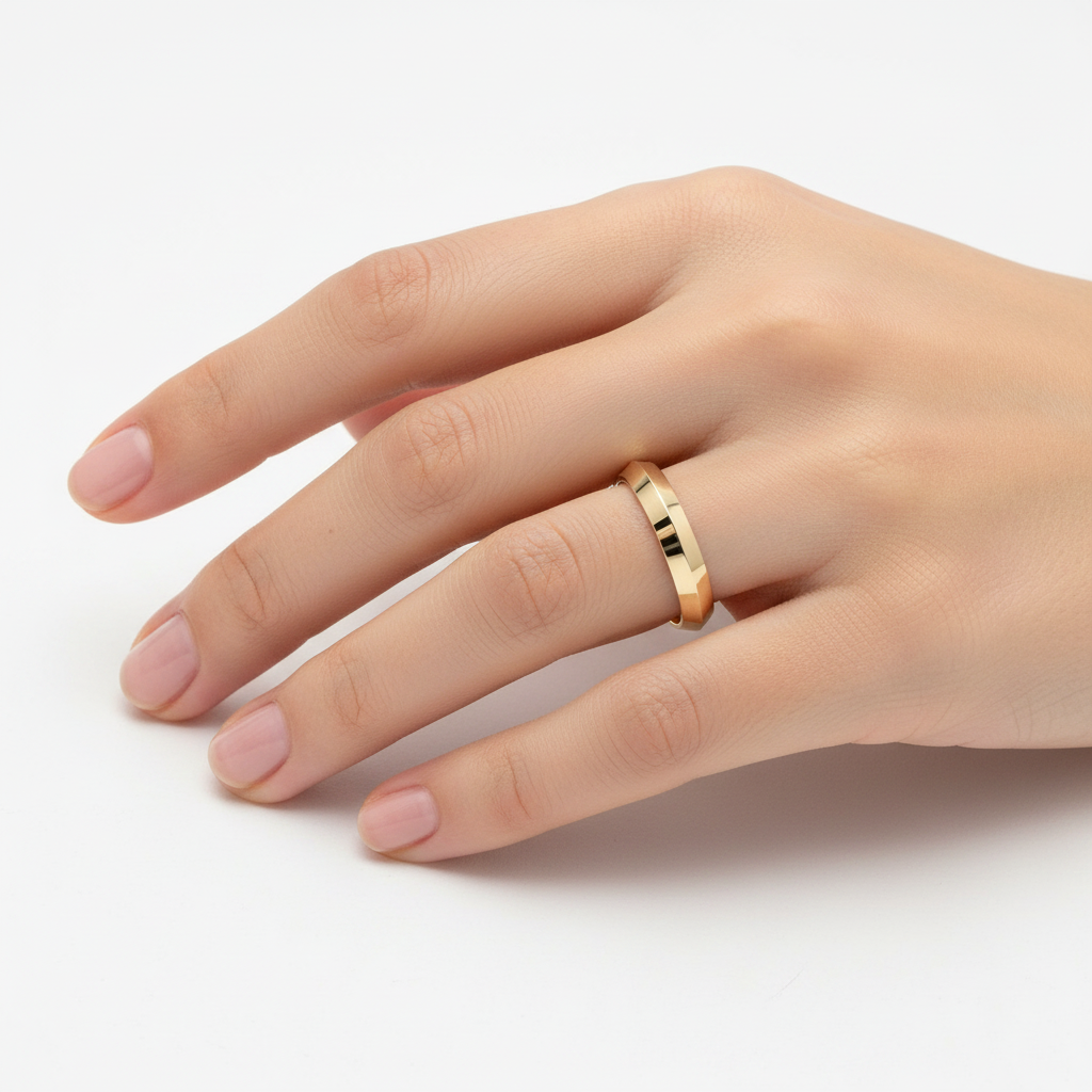 14k yellow gold wedding band with a knife edge design, 5mm width, handcrafted by JewelryNest, shown on a model.