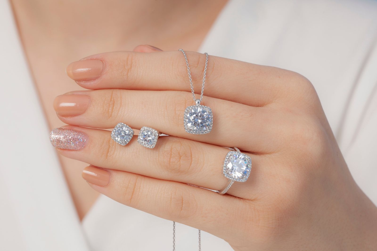 Assorted Diamonds Necklace, Earrings, Rings On woman Hand  